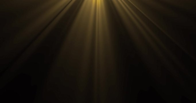 Gold yellow light, sun beams from above on black background. Golden sunbeam light rays magic glow radiance effect