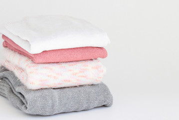 Warm, cashmere sweaters on the table.