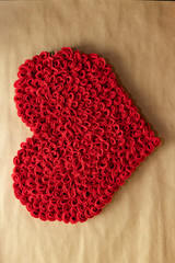 Valentine's Day. Red and white hearts on craft paper background. Beautiful red heart of roses, felt handmade. Beauty.