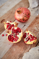 ripe organic pomegranate on teh wooden background