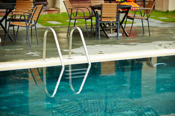 Resort hotel swimming pool, ladder on edge 