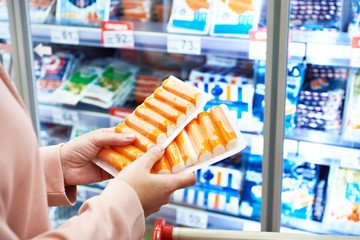 Crab sticks in hands buyer at store