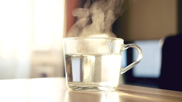 Hot water in a transparent cup. HD, 1920x1080, slow motion
