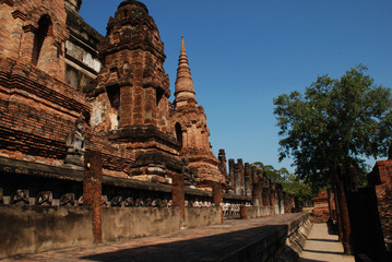 Pagodas with blue sky and tree in sukhothai Historical Park.