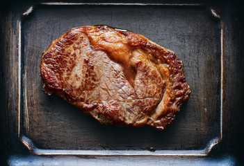 Hot angus ribeye steak on metal background