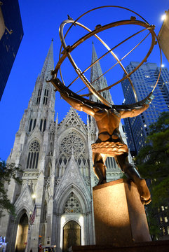New York, USA - May 25, 2018: The statue of Atlas in Rockefeller Center stands across from St Patrick's Cathedral.