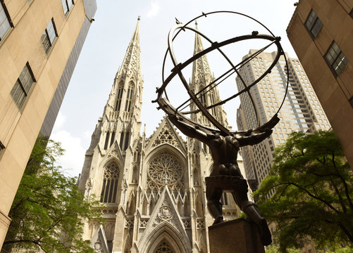 New York, USA - June 8, 2018: The statue of Atlas in Rockefeller Center stands across from St Patrick's Cathedral.