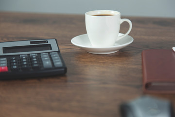 Fototapeta na wymiar calculator with notepad and coffee