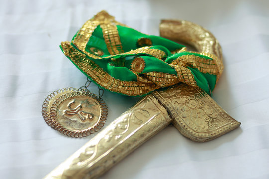 Badik Bugis, a traditional weapon of the Bugis Makassar tribe in a gold frame. Not only serves as a complementary accessory to traditional clothes, badik is also symbolized as the owner's pride.