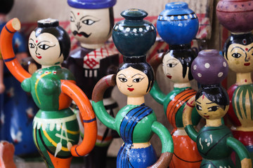Naklejka premium Selective Focus On Channapatna Toys Of Indian Cultural Women In Traditional Sari Costume