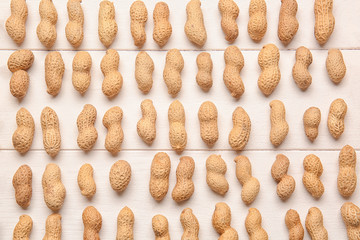 Peanuts on white wooden background