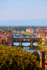 Beautiful landscape view of amazing Florence city with famous medieval stone bridge Ponte Vecchio and the Arno River at sunset. Firenze scenery panorama, Italy Europe. Italian summer vacation.