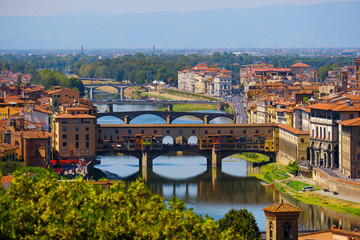 Fototapeta na wymiar Beautiful landscape view of amazing Florence city with famous medieval stone bridge Ponte Vecchio and the Arno River at sunset. Firenze scenery panorama, Italy Europe. Italian summer vacation.