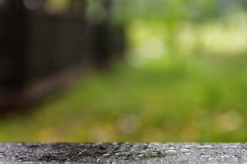 Wood floor with blurred trees of nature park background and summer season,