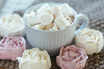 Homemade marshmallows around grey cup with cocoa or hot chocolate over the top.