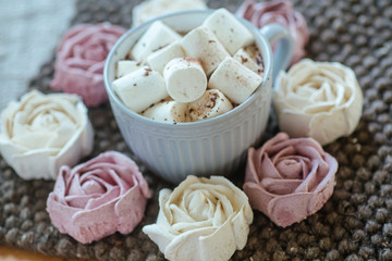 Homemade marshmallows around grey cup with cocoa or hot chocolate over the top.
