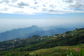 Fototapeta premium The road from the mountains with foggy blue sky.