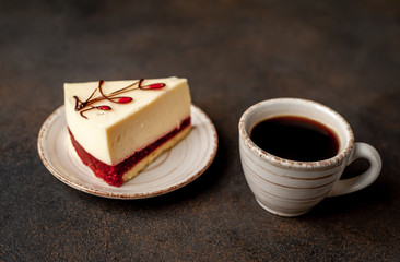 Coffee and tasty cheesecake on a plate on a stone background , breakfast concept