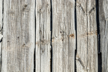 Fence wall made of old weathered wooden boards as background