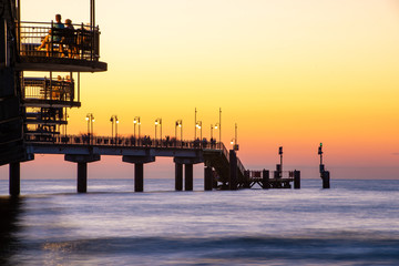 Baltic sea at beautiful sunset in Miedzyzdroje beach. Polish baltic coast. Famous city among the tourist. Pier at sunset