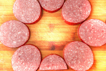 slicing sausage on a cutting Board