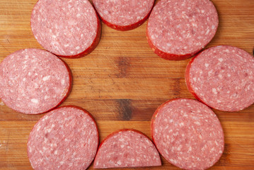 slicing sausage on a cutting Board