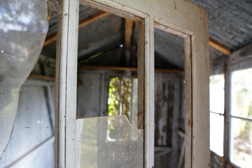 wooden countryside cabin door with broken glass 