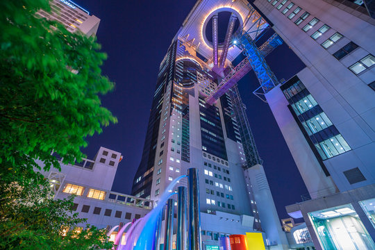 Osaka, Japan - April 28, 2017: prospective view of Umeda Sky Building and fountains in Kita-ku district by night. The Floating Garden Observatory is one of the most popular attractions in Osaka