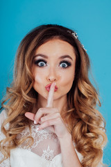 Naklejka premium beautiful bride hairstyle curls a finger from lips