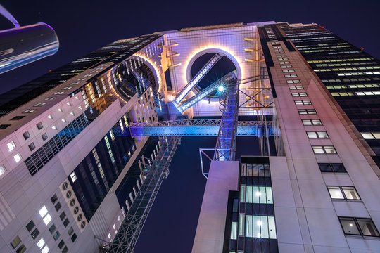 Osaka, Japan - April 28, 2017: looking up at the modern Umeda Sky Building in Kita-ku district by night. The Floating Garden Observatory is one of the most popular attractions and landmark in Osaka.