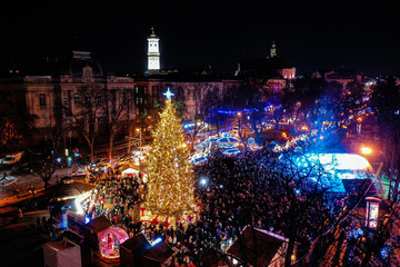Fototapeta na wymiar Opening of Christmas tree near Opera House in Lviv, Ukraine. View from drone