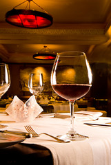 Red wine glass on table in high end restauant