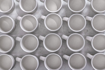 Many ceramic white cup pattern, seamless abstract creative cover background, top view, copy space, minimal concept of creativity and art in the potter's studio
