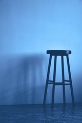 Classic blue color high stool. Monochrome background. Copy space.