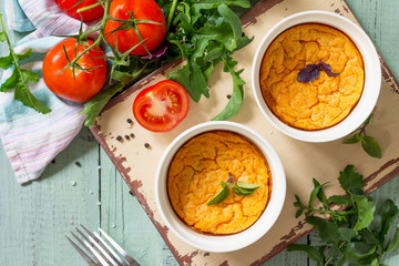 Summer breakfast. Diet and healthy food. Baked omelet with tomatoes on a kitchen wooden table. Top view on a flat background.