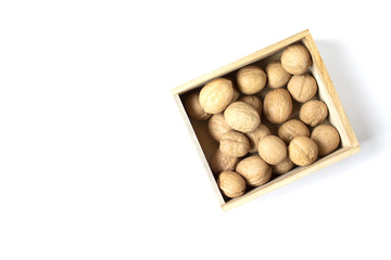 White background with walmuts in the wooden box. Copy space. Place for text and design. Top view. Flat lay