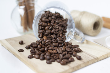 Scattered coffee beans. Glass cup