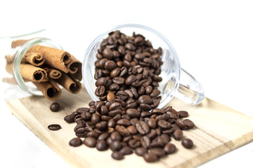 Scattered coffee beans. Glass cup. Brown cinnamon