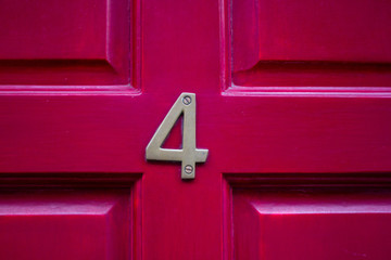 House number 4 on a lucky red door