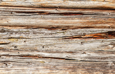 Old rough wooden logs with cracks as background