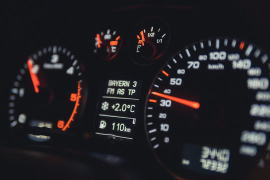 Close up shot of a speedometer in a car. Car dashboard. Dashboard details with indication lamps.Car instrument panel. Dashboard with speedometer, tachometer, odometer. Car detailing.