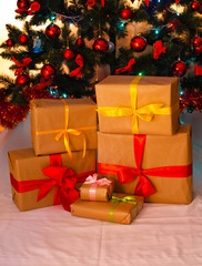 Boxes with gifts on a light, blue background and under the Christmas tree. Gift in the hand. Christmas presents, Nicholas Day, Valentine's Day. Bright boxes with bright ribbons Gifts in Macro.