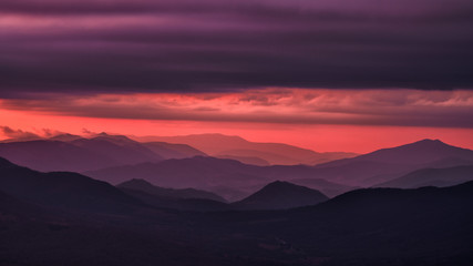 Splendid mountain sunrise. Mountains silhouettes on a beauty background. Bieszczady Mountains Poland.