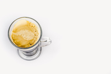 GLASS CUP OF COFFEE ON WHITE BACKGROUND