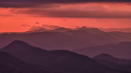 Splendid mountain sunrise. Mountains silhouettes on a beauty background. Bieszczady Mountains Poland.