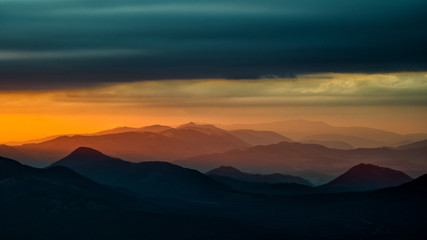 Splendid mountain sunrise. Mountains silhouettes on a beauty background. Bieszczady Mountains Poland.