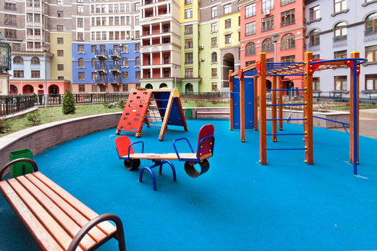 Colour Children Playground In New Residential Area Complex With Modern Blue Background Copy Space. Urban Development Common Area Concept Image