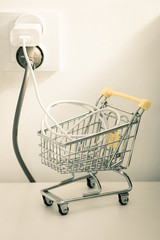 electricity price increases, Concept, Shopping trolley with cable and electrical outlet