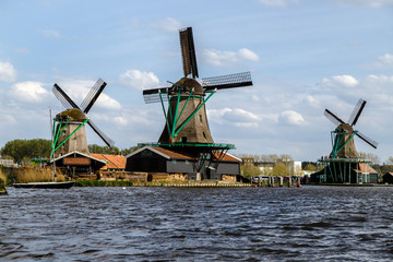 Authentic dutch windmills on the water channel in the historic village of Zaanse Schans, a...