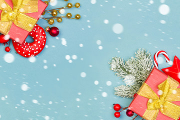 Christmas border background. Red gifts, holly berries and green  with snow